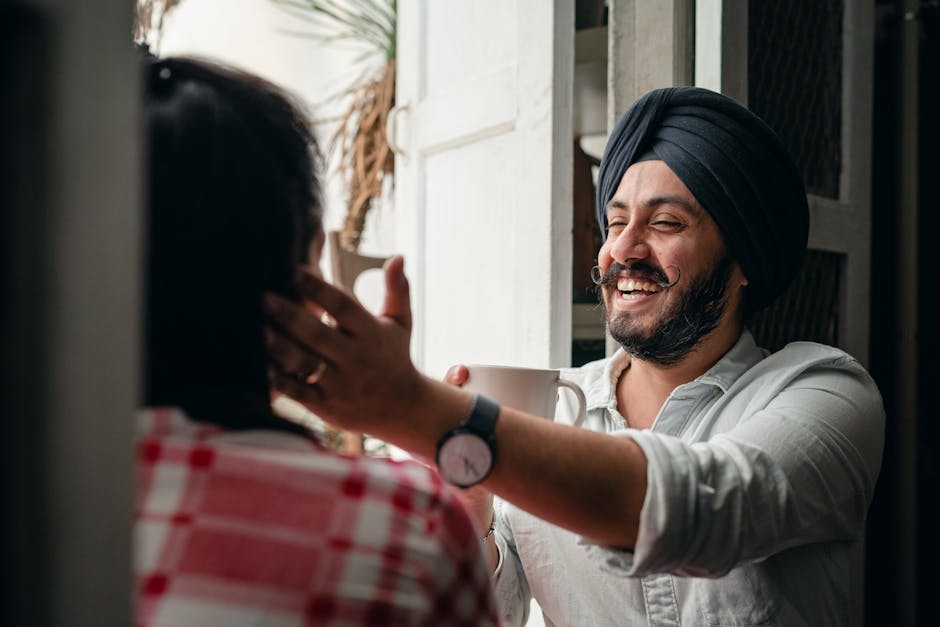 Happy modern Indian man with cup of <a href='https://printsondemands.com/chocolate-and-roses-for-all-on-coffee-mug' target='_blank' rel='follow' srcset=