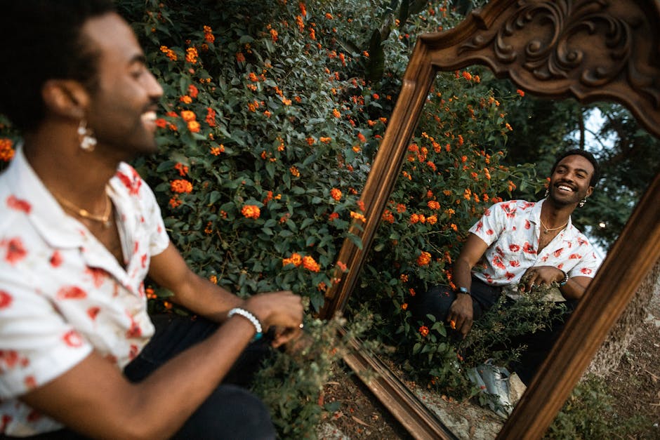 Smiling Man Looking at Himself in a Mirror