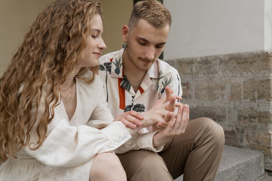 Couple Holding Hands While Sitting on Steps